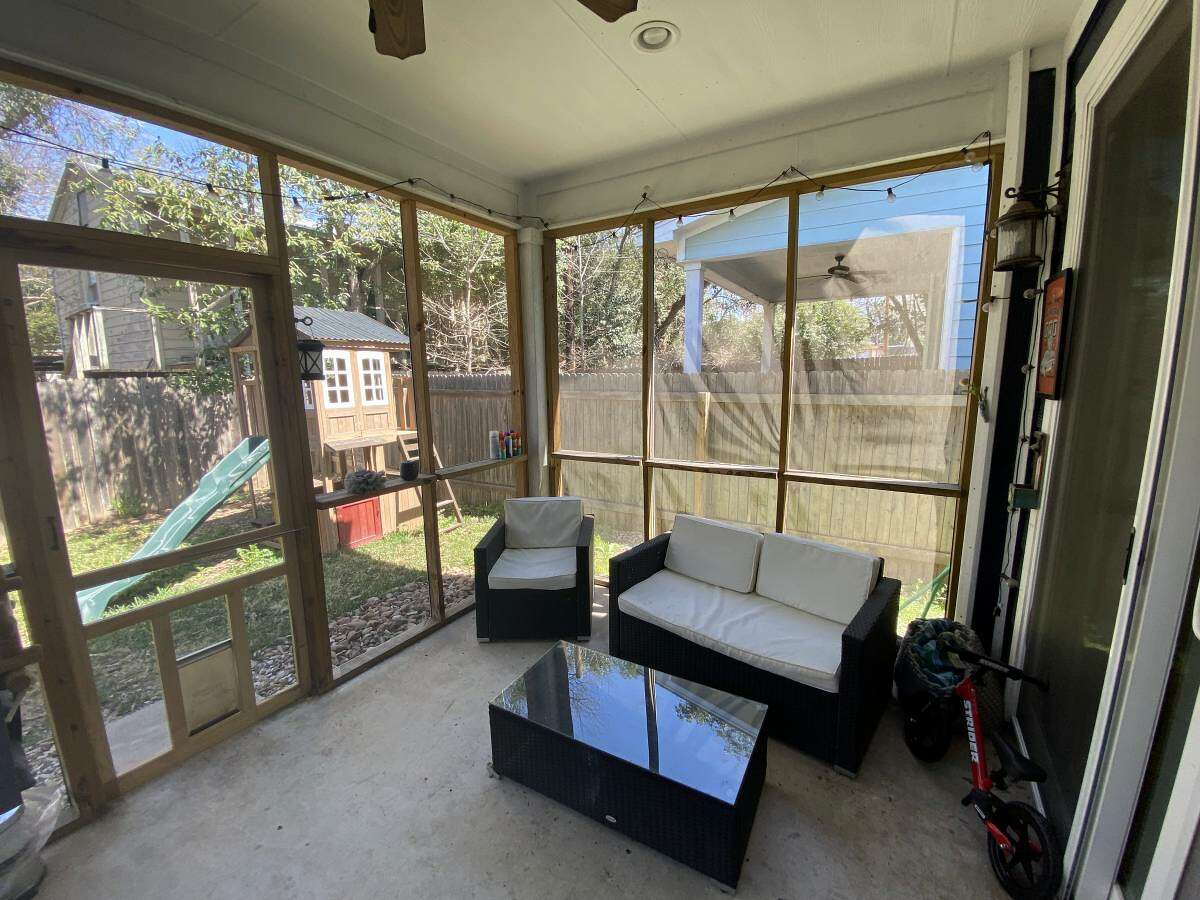 This enclosed patio looks cozier than the living room.