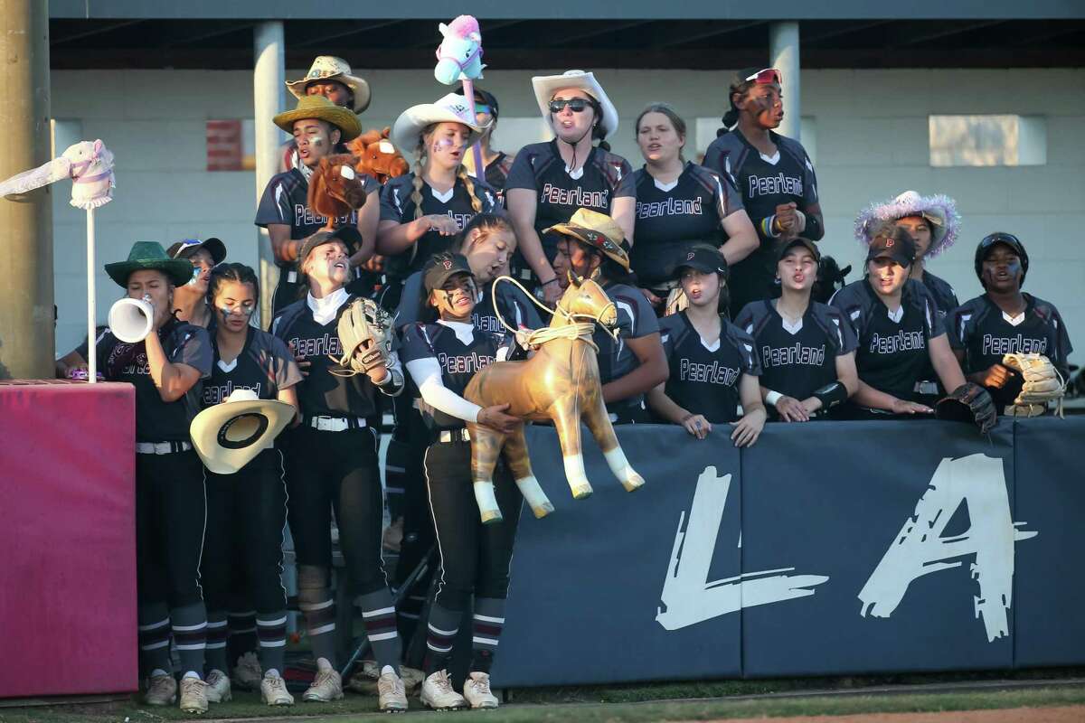 Pearland players cheer on the Lady Oilers during their Class 6A softball playoff game Thursday night against Clear Springs.