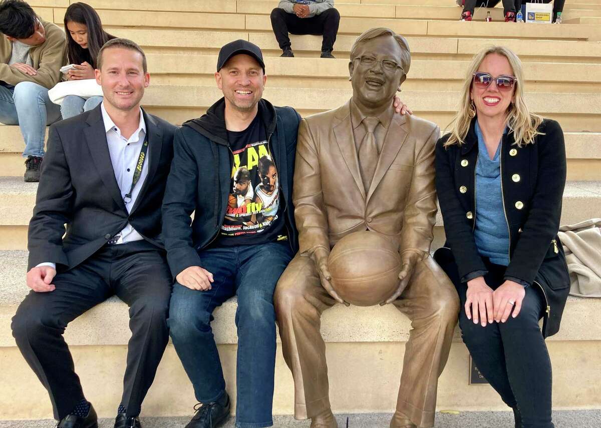 Golden State Warriors president and chief operating office Brandon Schneider, far left, takes a photo with the new Ed Lee statue at Chase Center in San Francisco.
