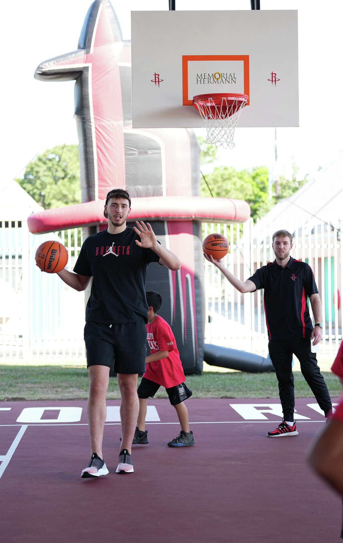 Houston Rockets center Alperen Sengun shoots hoops in the renovated outdoor basketball court during a ribbon cutting ceremony for renovations at Moody Community Center on Thursday, May 12, 2022 in Houston. The Houston Rockets and the Fertitta family along with Memorial Hermann pitched in to help spruce up the Moody Community Center.
