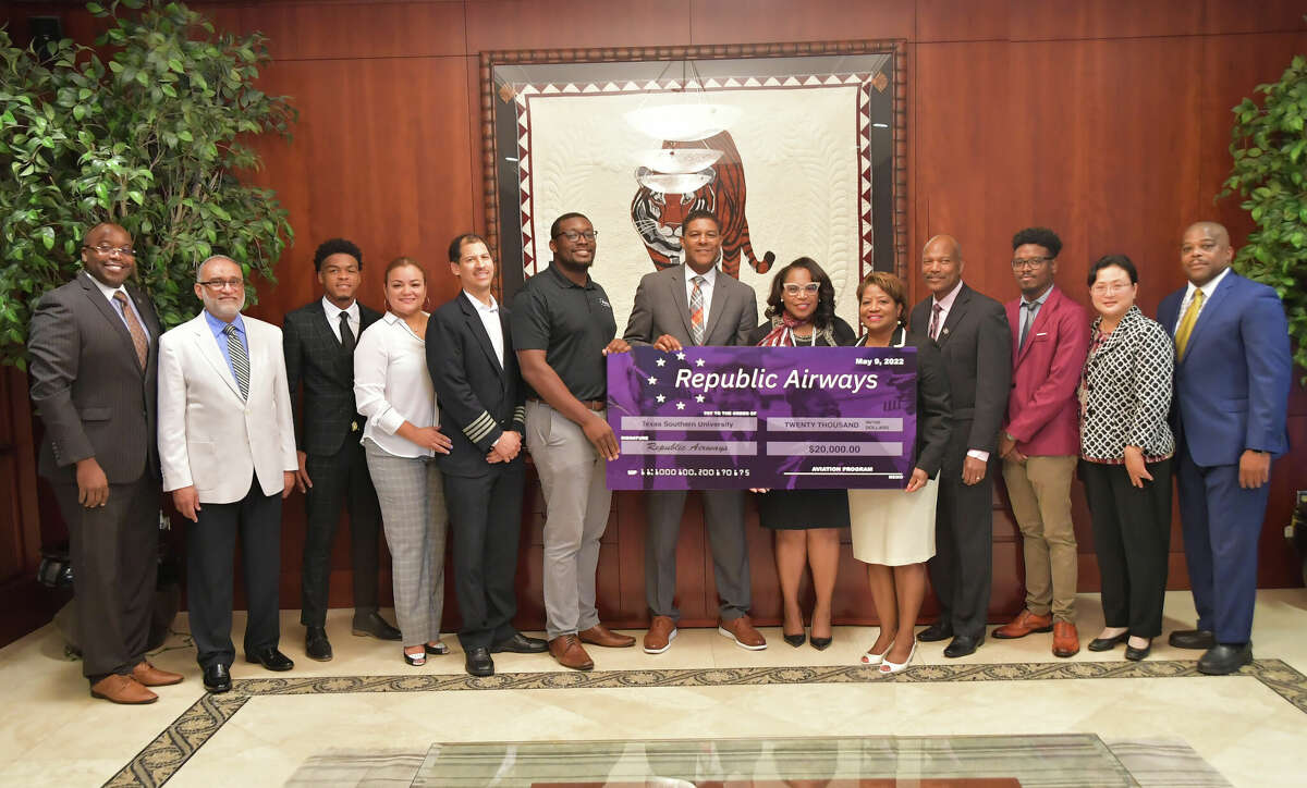 TSU President Lesia L. Crumpton-Young receives a check for $20,000 from Republic Airway's campus recruiter, Bradley Murphy and senior manager of diversity programs and education, Darrell Morton, Jr. along with Rhonda Arnold, the chief community relations officer with Houston Airports. Also pictured are TSU aviation students, program advisory committee members, faculty and administration