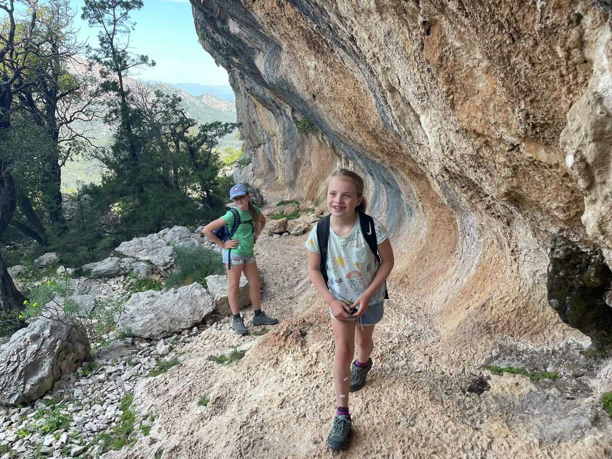 Cecilia and Jane take a break beneath rock cliffs on the trail to Tiscali.