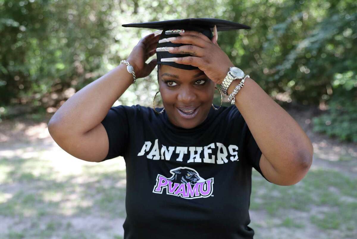 LaTrinidy Mike poses with her graduation cap at Meyer Park on Thursday, May 12, 2022 in Spring. Mike, who was laid off in Dec. 2020 during the pandemic, is graduating from Prairie View A&M University with a Bachelor of Business Administration.