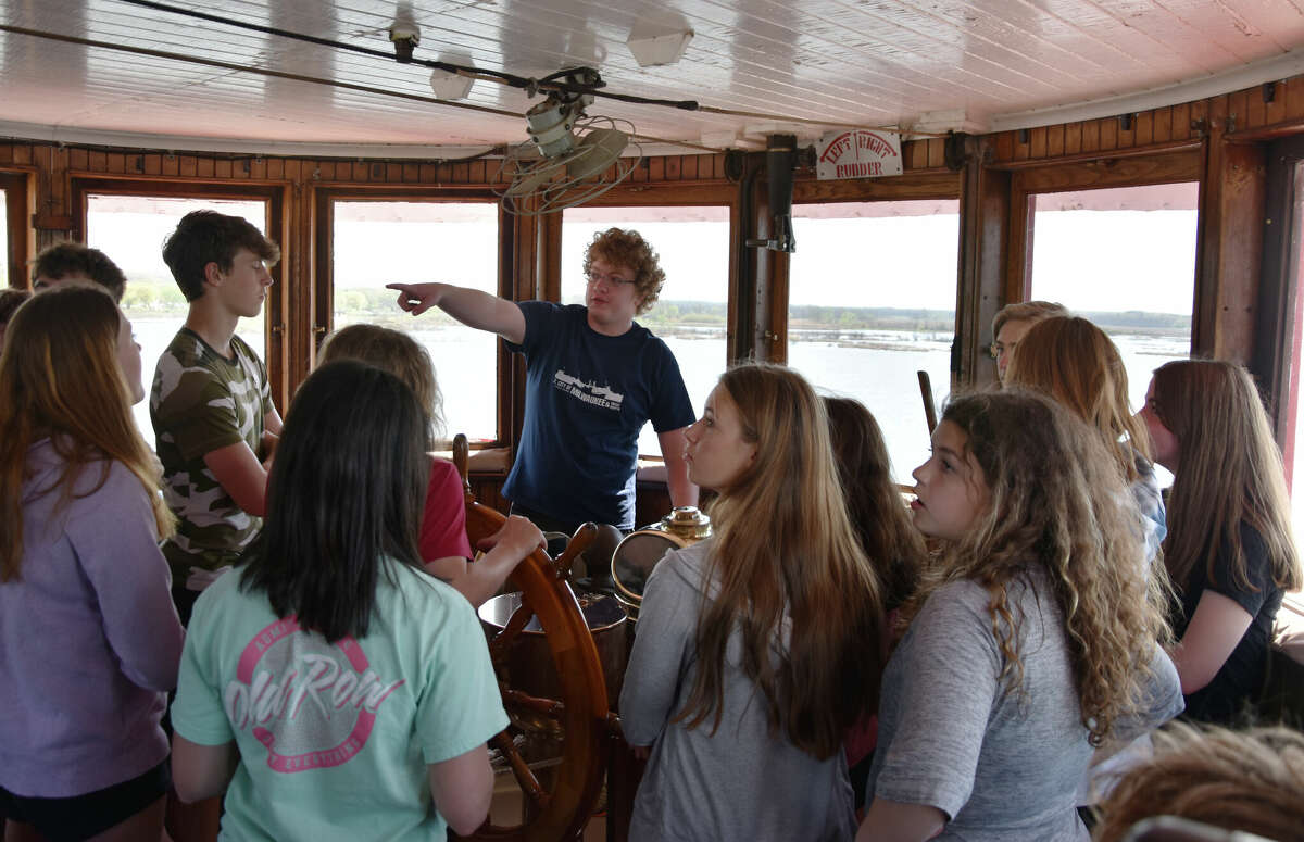 Titus Lind (right) points to parts of the ship during a tour of the SS City of Milwaukee in Manistee. 