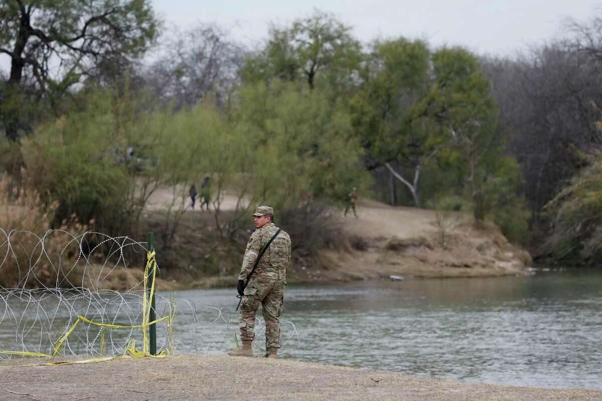 A Texas National Guardsman stands by a boat ramp on the Rio Grande near the international bridge in Eagle Pass earlier this year. Texas Military Department officials did not give a specific number for the current deployment level but said it has “over 5,000 service members” dedicated to Operation Lone Star.