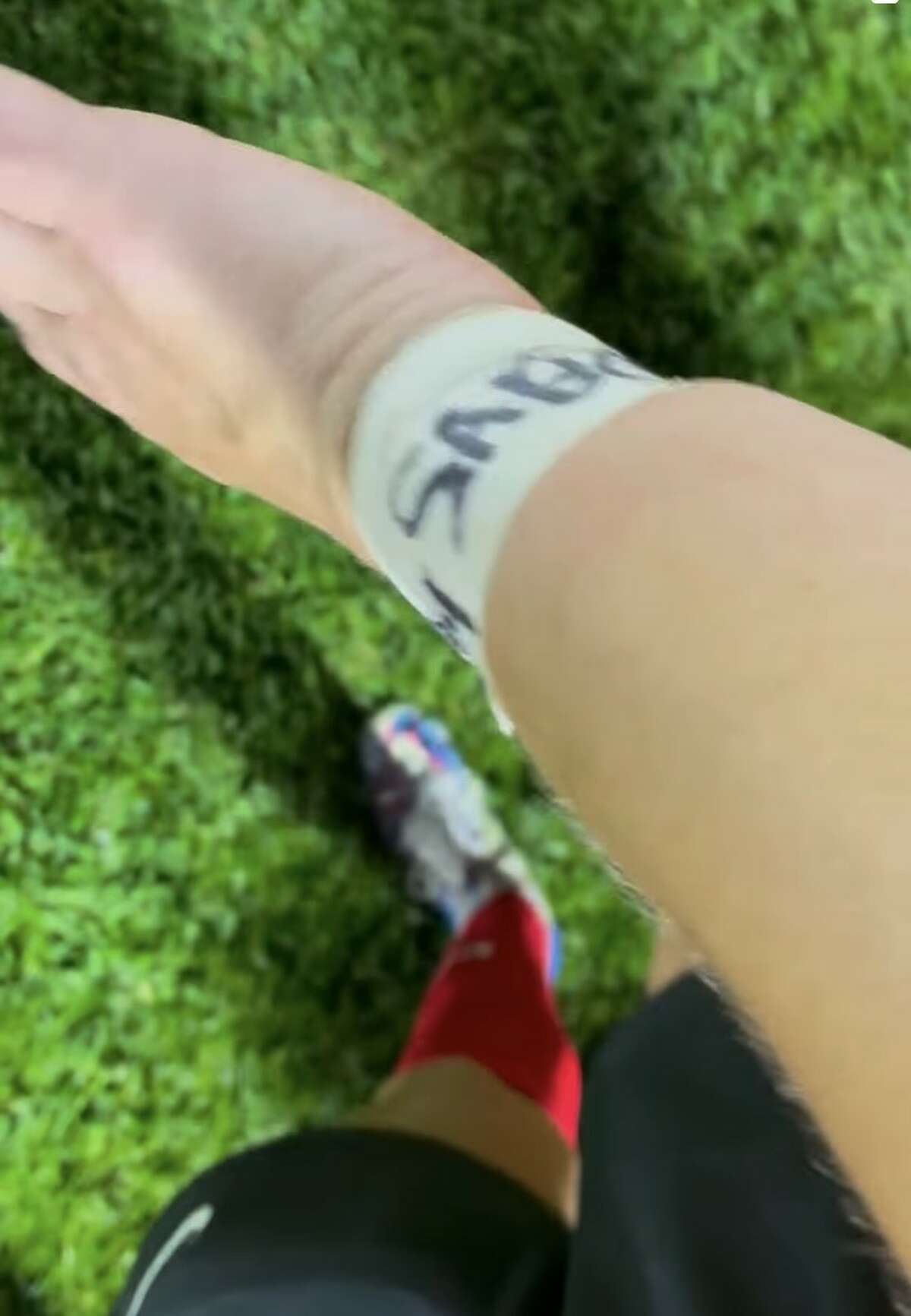 Alton High soccer player Emily Baker shows the prediction she wrote on her wrist tape at Thursday's 4-0 win over Belleville West. Baker predicted three goals for "Baby Sabo," and she scored three goals. AHS coach Gwen Sabo is expecting a baby in June.