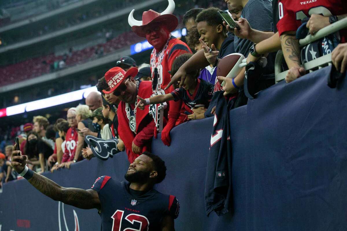 Houston Texans wide receiver Nico Collins (12) takes a selfie with a fan’s phone as he celebrates the Texans 41-29 win over the Los Angeles Chargers Sunday, Dec. 26, 2021 in Houston.