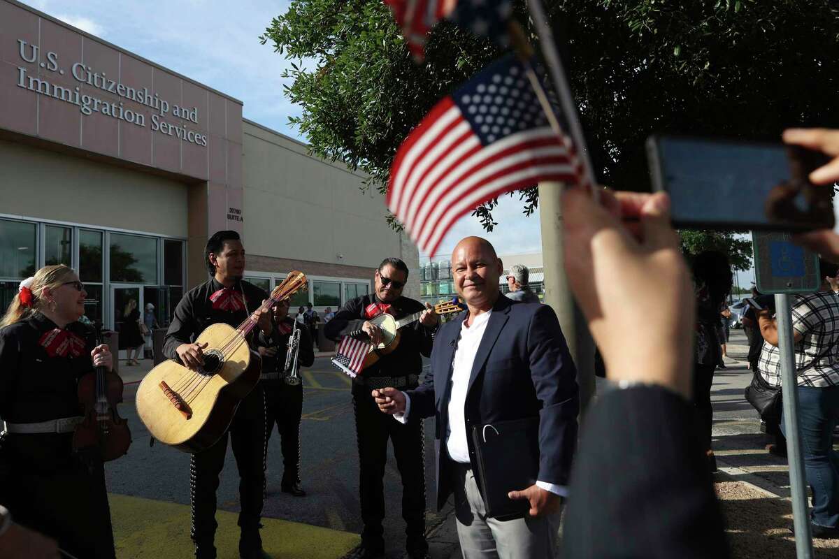 Samuel Monsivais, 53, is serenaded by Mariachi Sol y Luna after his citizenship ceremony at the United States Citizenship and Immigration Service Field Office on the far North Side on Friday, May 13, 2022. Mariachi Sol y Luna whose members are relatives, serenaded Monsivias before and after the ceremony. Monsivais, who is from Durando, Mexico, has held a green card since 2015. According to officials, around 300 people were naturalized during ceremonies held throughout the day.