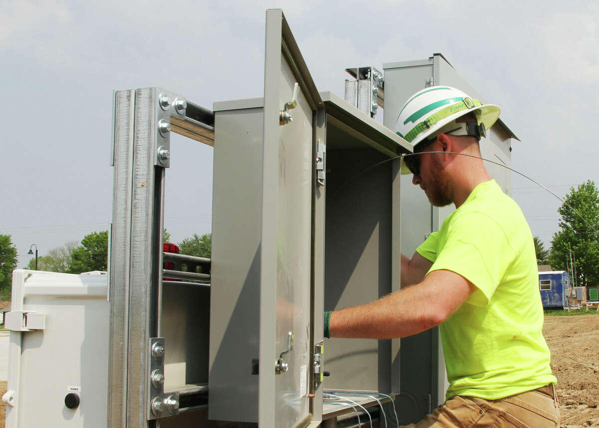 Brian Johnson, of Brighton, feeds wire through the main junction box during construction of a new recreational complex at Glazebrook Park in Godfrey. 