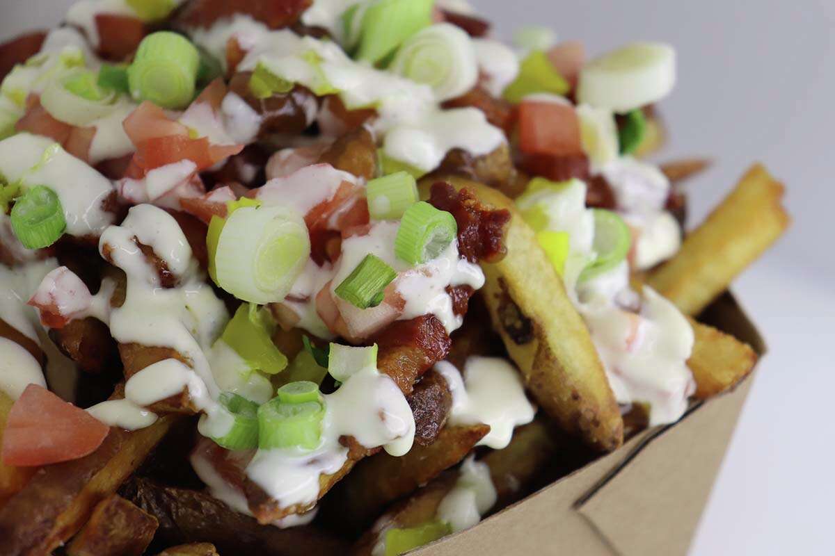 Twisted fries at Jefferson Fry Co., with bacon, gravy, diced tomato, banana peppers, garlic aioli?and green onion.