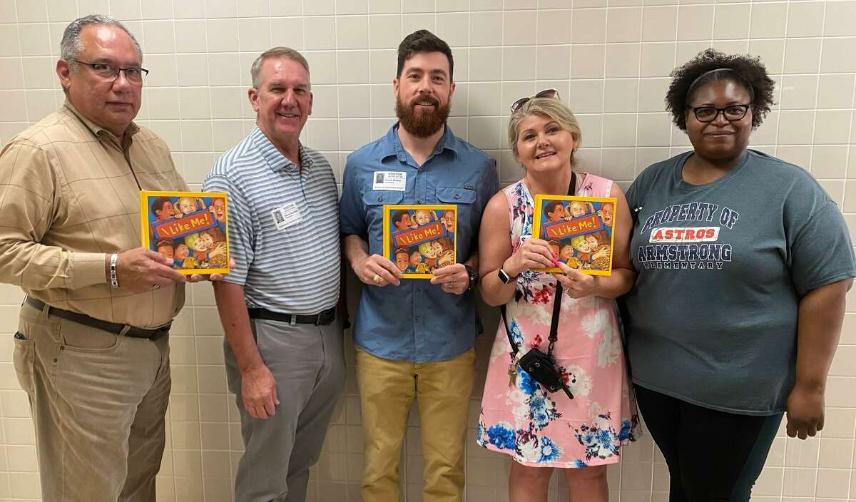 Pictured from left are Conroe Rotarians Hector Forestier, Denny Buckalew and Club President Travis Walker. Along with Sondra Hernandez they delivered the 2022 I Like Me books Friday morning to first graders at Armstrong Elementary. They are pictured with Armstrong school counselors April Castille and Kristi Evans.