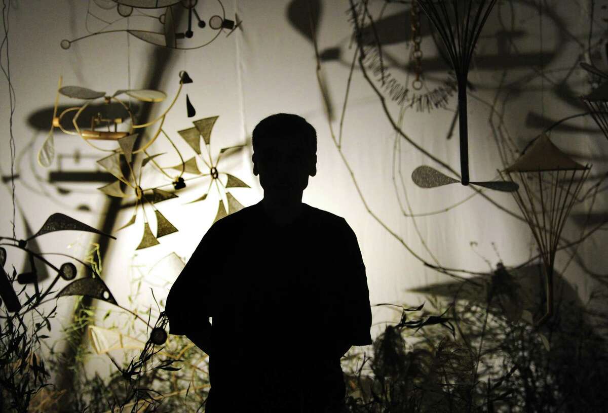 Japanese sculptor and sound artist Akinori Matsumoto poses amongst his installation entitled: Sound Garden, at the Flinn Gallery at Greenwich Library in Greenwich, Conn., on Thursday May 12, 2022. The exhibit, which is the final of the 2021-22 season, runs until June 15th.