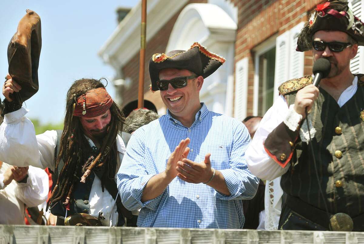 Milford Mayor Ben Blake, center, is joined by a band of invading pirates during the annual Pirate Day at Lisman Landing in Milford, Conn. on Sunday, June 6, 2021.