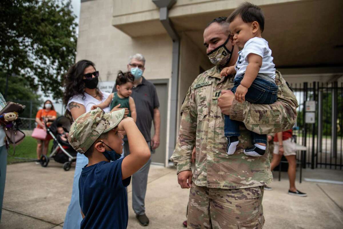 Brandon Gonzalez, 6, salutes his father, Capt. Andrew Gonzalez, at a sendoff in Austin for Texas Army National Guard soldiers about to deploy to the Middle East. GIs serving in Task Force Spartan Shield come from across the Lone State State. (Sergio Flores/San Antonio Express News)
