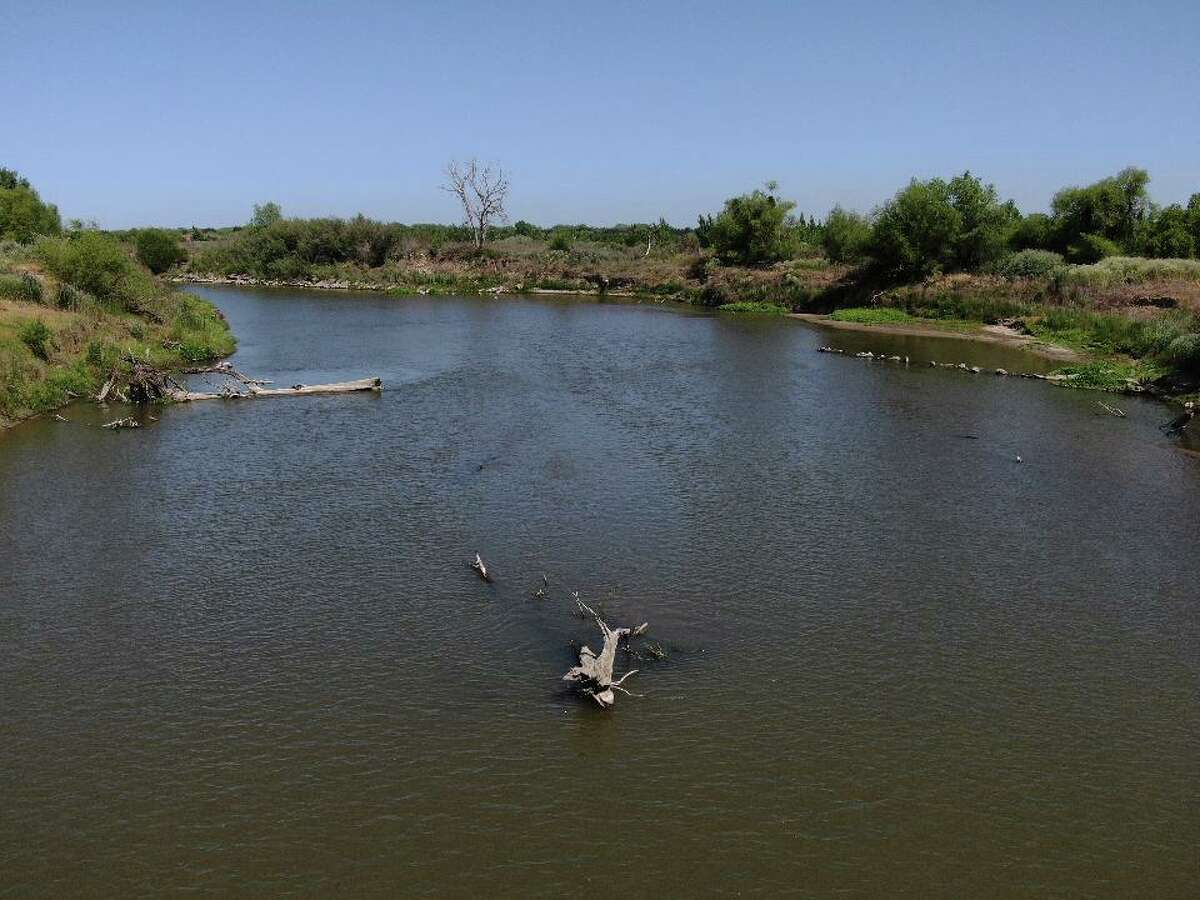 A branch lays in the shallow San Joaquin River at Dos Rios Ranch on Friday, May 7, 2021 in Modesto, Calif.