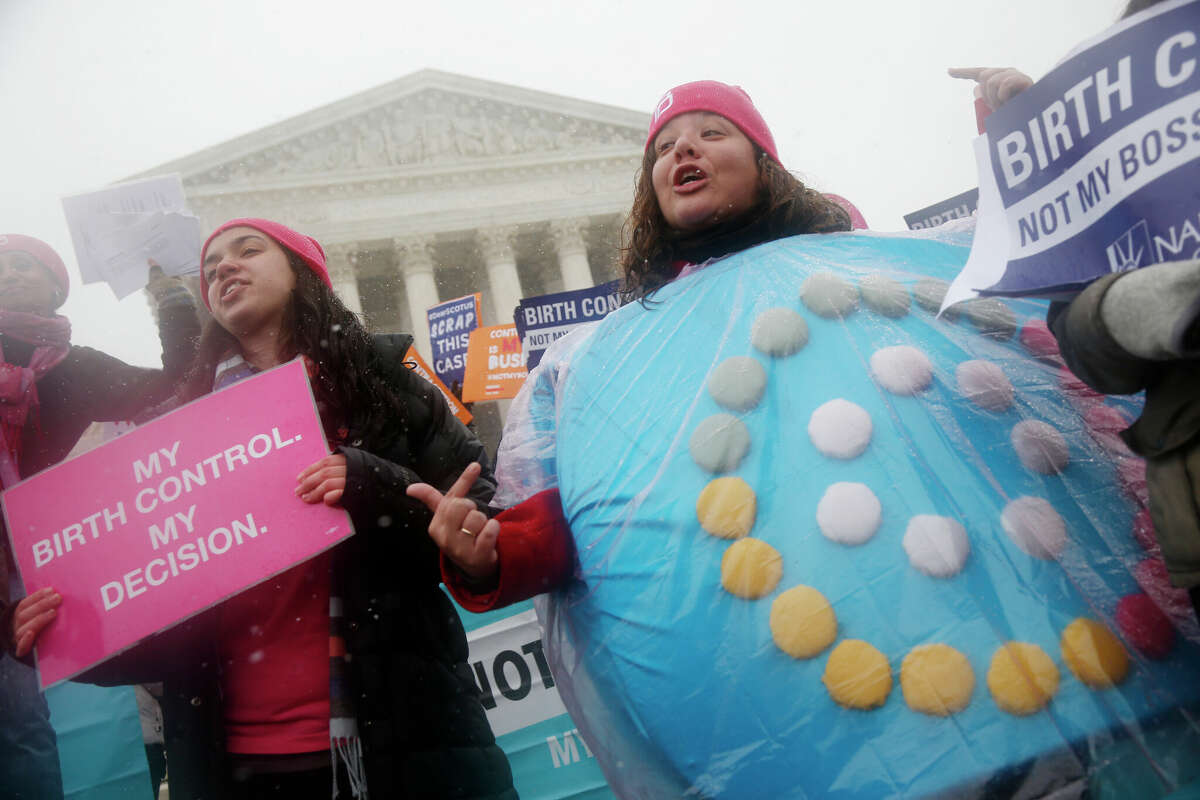 Protesters, including one wearing a birth control pills costume, participate in a 2015 demonstration in front of the Supreme Court in Washington.