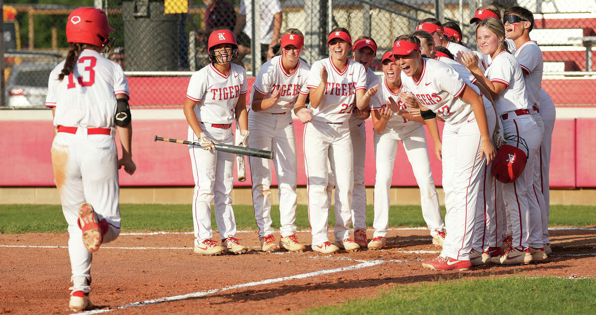 Teammates wait for Katy's Kailey Wyckoff (13) to make it home after she hit a home run off of Cinco Ranch's Chela Kovar in the third inning during a Region III-6A quarterfinals softball game at Katy High School on Friday, May 13, 2022 in Katy. Katy beat Cinco Ranch 10-0 in six innings.
