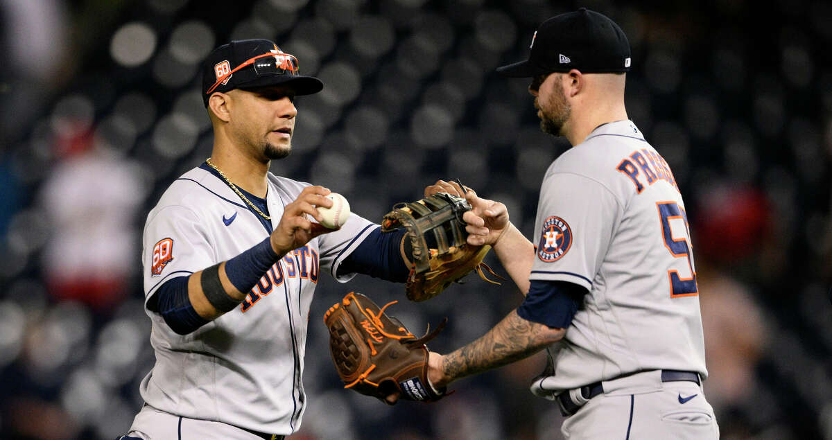 Houston Astros first baseman Yuli Gurriel, left, and reliever Ryan Pressly celebrate after a baseball game against the Washington Nationals, Friday, May 13, 2022, in Washington. (AP Photo/Nick Wass)