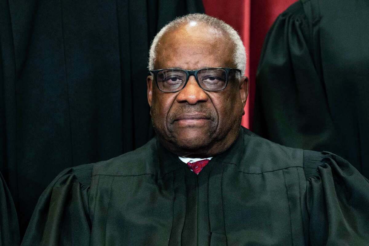 FILE - Justice Clarence Thomas sits during a group photo at the Supreme Court in Washington, on Friday, April 23, 2021. Supreme Court justices have long prized confidentiality. It's one of the reasons the leak of a draft opinion in a major abortion case last week was so shocking. But it's not just the justices' work on opinions that they understandably like to keep under wraps. The justices are also ultimately the gatekeepers to information about their travel, speaking engagements and health issues. (Erin Schaff/The New York Times via AP, Pool, File)