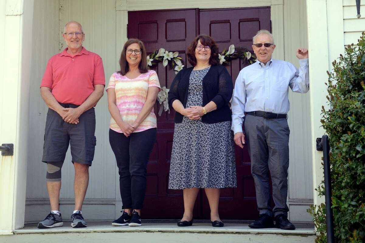 From left, Gordon Harris, Linda Harris, Rev. Lucille Fritz and Robert Margolies, members of the Valley Refugee Resettlement Project, pose in front of Huntington Congregational Church, in Shelton, Conn. May 13, 2022.