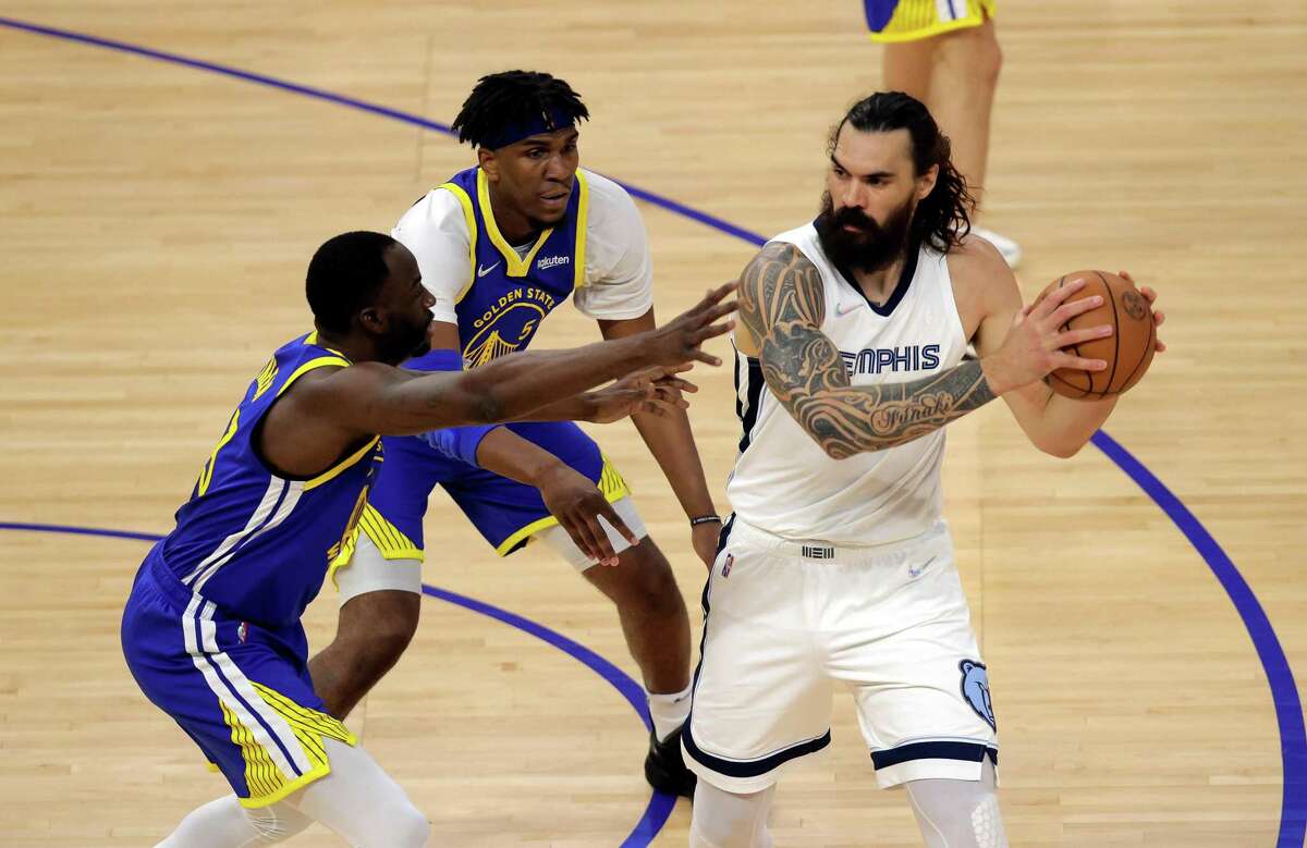 Draymond Green (23) and Kevon Looney (5) defend against Steven Adams (4) in the first quarter as the Golden State Warriors played the Memphis Grizzlies in Game 6 of the Western Conference Semifinals of the NBA Playoffs at Chase Center in San Francisco, Calif., on Friday, May 13, 2022.