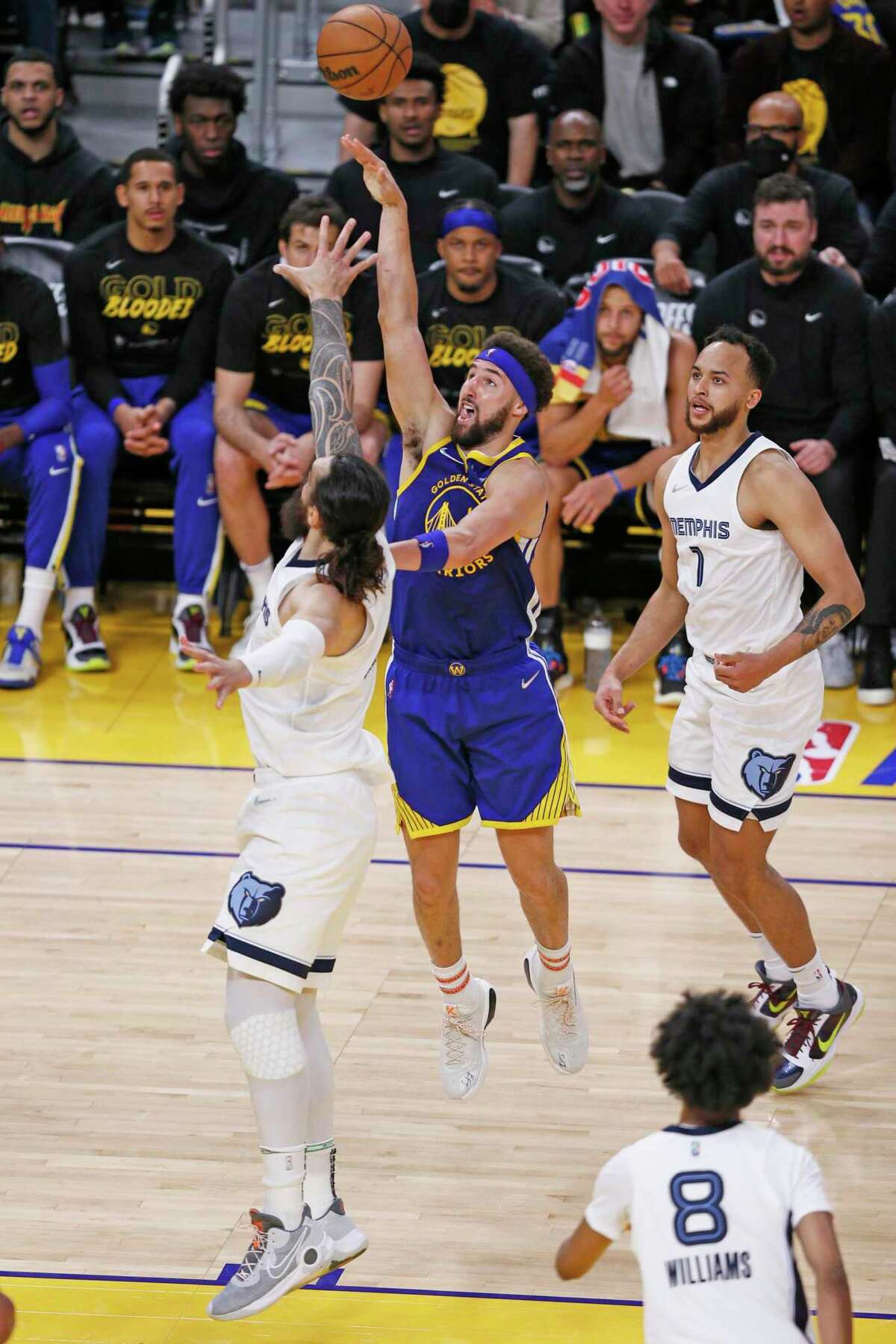 Golden State Warriors guard Klay Thompson (11) shoots and Warriors center Kevon Looney (5) grabs the offensive rebound in the fourth quarter of Game 6 of the Western Conference Semifinals at Chase Center, Friday, May 13, 2022, in San Francisco, Calif.