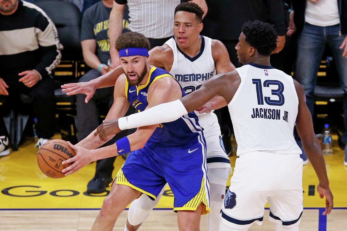 Golden State Warriors guard Klay Thompson (11) is double teamed by the Memphis Grizzlies in the fourth quarter of Game 6 of the Western Conference Semifinals at Chase Center, Friday, May 13, 2022, in San Francisco, Calif.