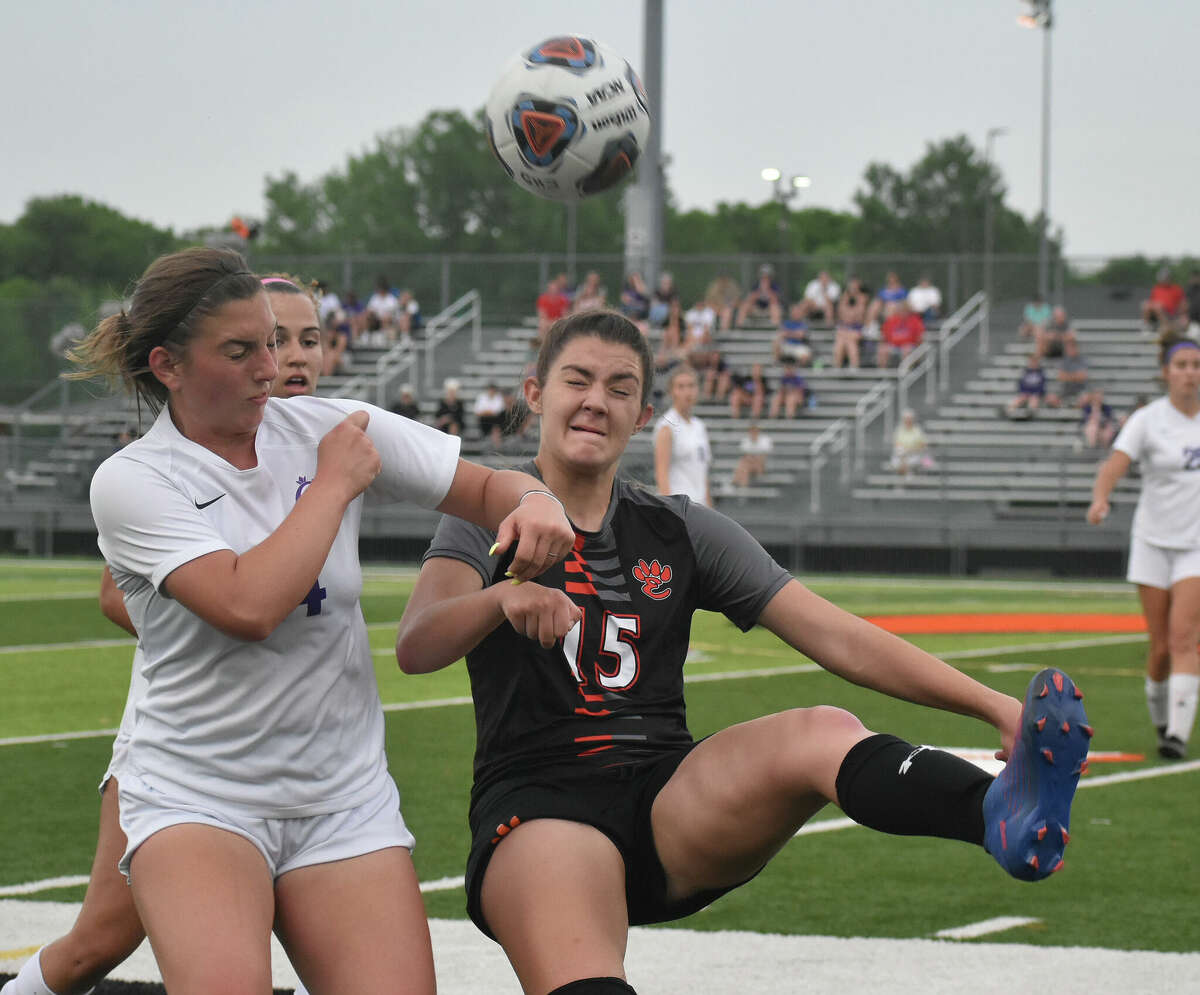 Edwardsville's Olivia Olson plays the ball over her head against Collinsville on Friday inside the District 7 Sports Complex in Edwardsville.