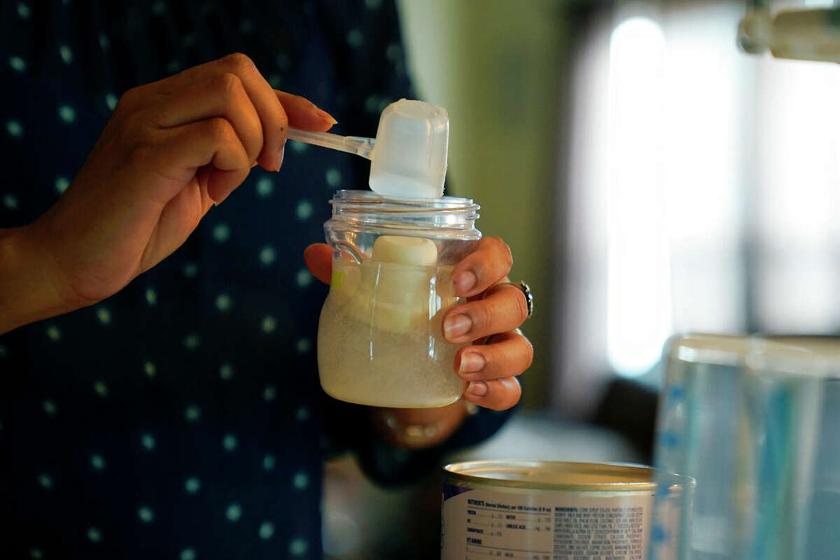 Olivia Godden prepares a bottle of baby formula for her infant son, Jaiden. Godden has reached out to family and friends as well as other moms through social media in efforts to locate needed baby formula, which is in short supply.