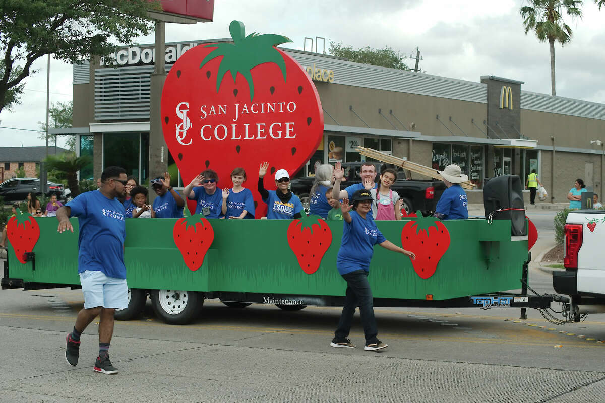 Representatives from San Jacinto College wave to the crowd during the Pasadena Strawberry Festival parade Saturday, May 14, 2022.