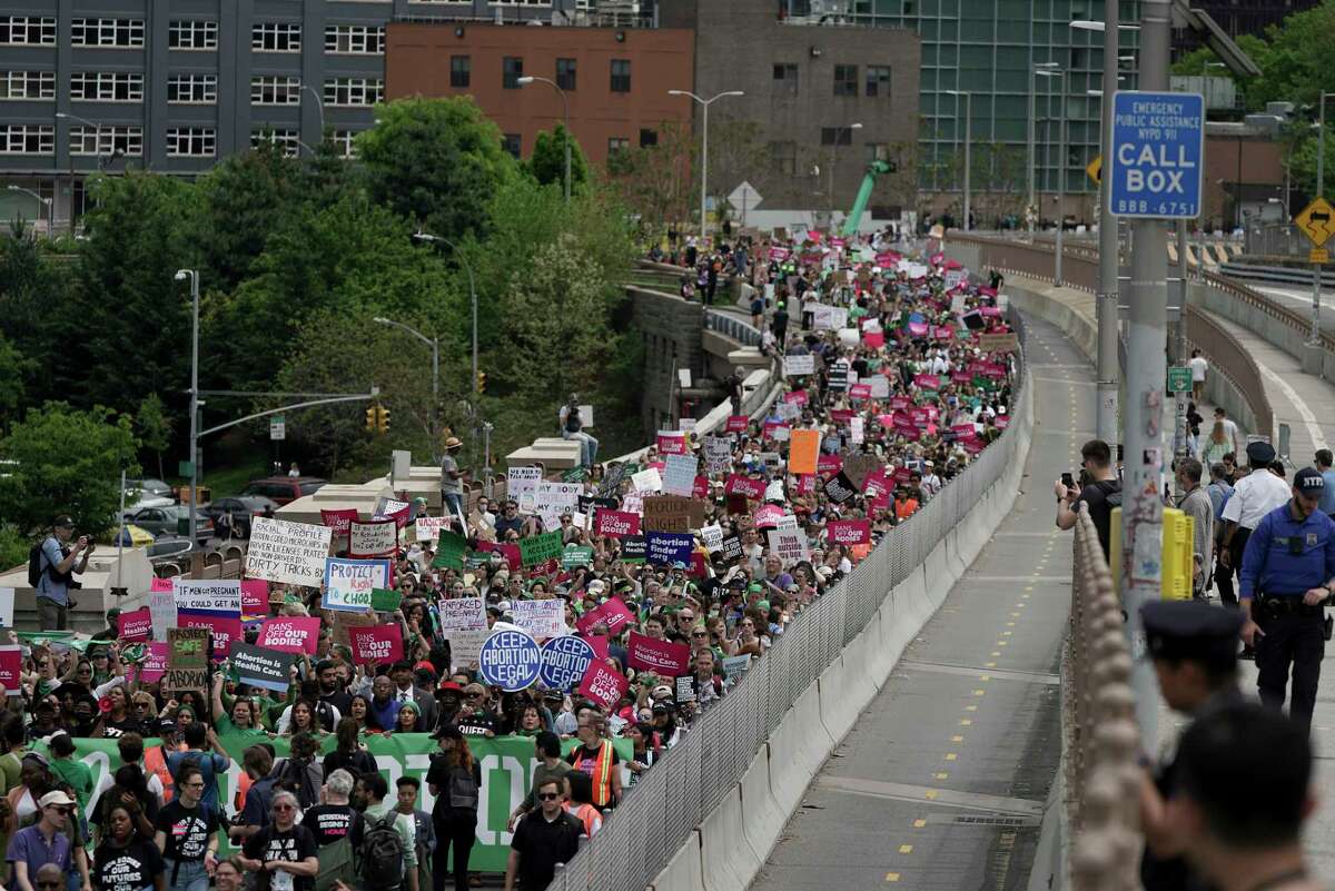 Protestors begin crossing the Brooklyn Bridge during an abortion rights demonstration, Saturday, May 14, 2022, in New York. Demonstrators are rallying from coast to coast in the face of an anticipated Supreme Court decision that could overturn women's right to an abortion.