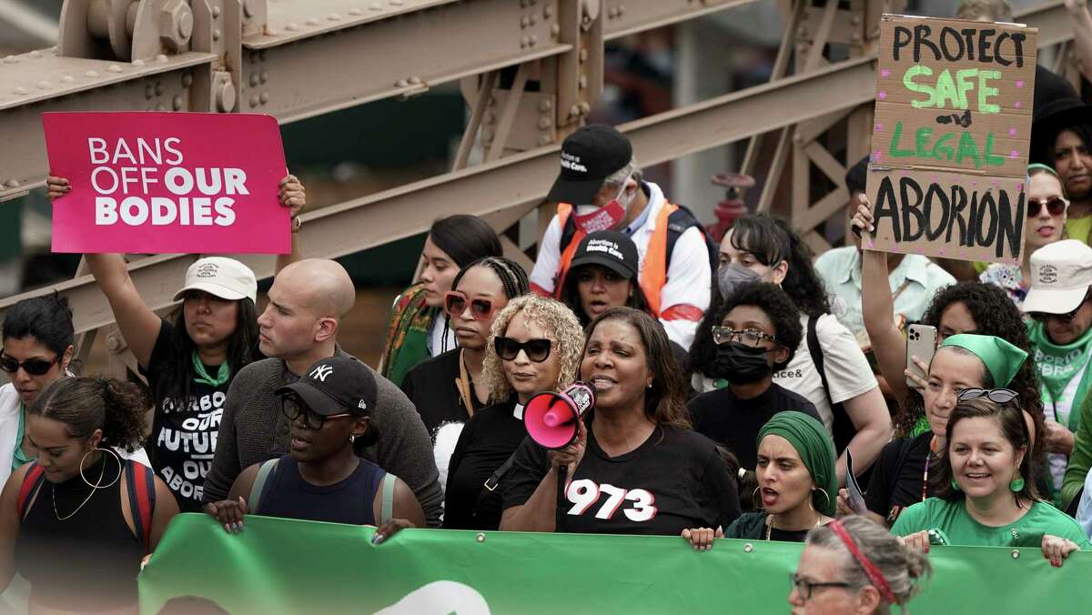 New York Attorney General Letitia James, front row third from right, marches with protestors across the Brooklyn Bridge during an abortion rights demonstration, Saturday, May 14, 2022, in New York. Demonstrators are rallying from coast to coast in the face of an anticipated Supreme Court decision that could overturn women's right to an abortion.