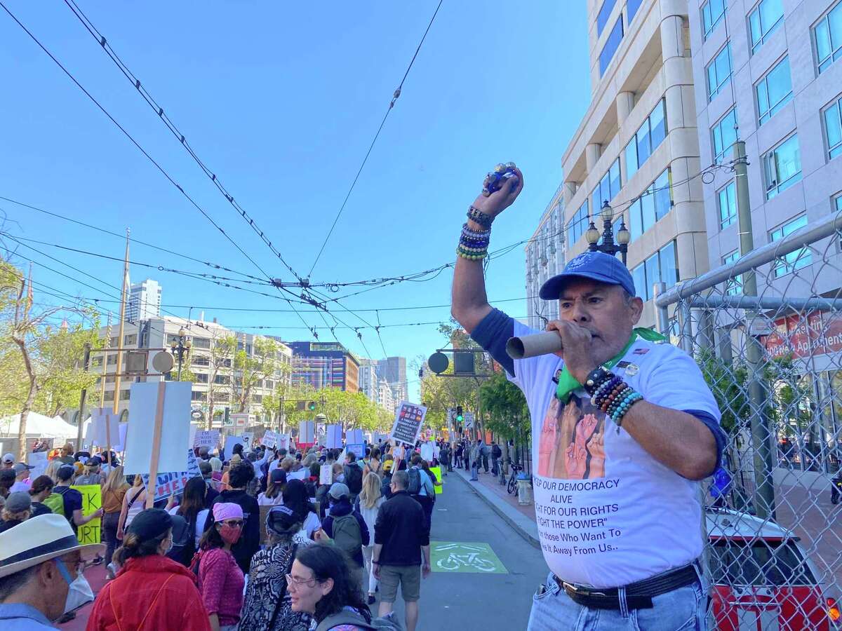 A man leads marchers in a series of call-and-response chants Saturday during a pro-choice demonstration in San Francisco. Marchers demanded abortion protections and said they are determined to shape the the national conversation around reproductive health care.