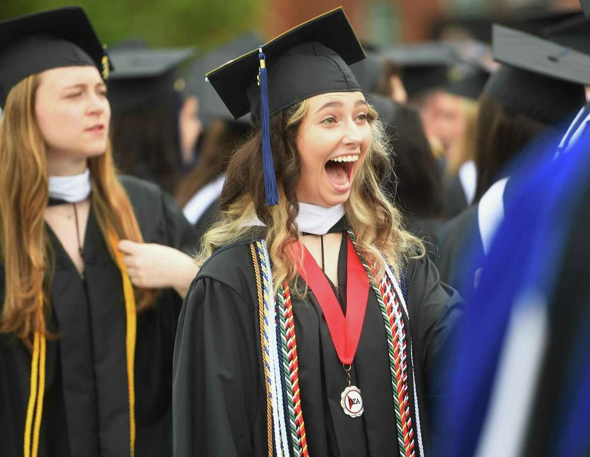 Madison Stout of Berwick, Pa., excitedly greets a fellow graduate during class of 2022 commencement ceremonies at Quinnipiac University in Hamden Saturday.