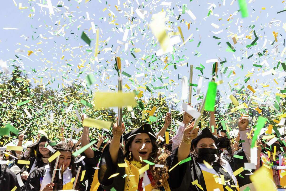 Zulma Tayun cheers as confetti flies during the 134th commencement at Mills College in Oakland. The event was the college’s final commencement as an independent institution before merging with Northeastern University in July.