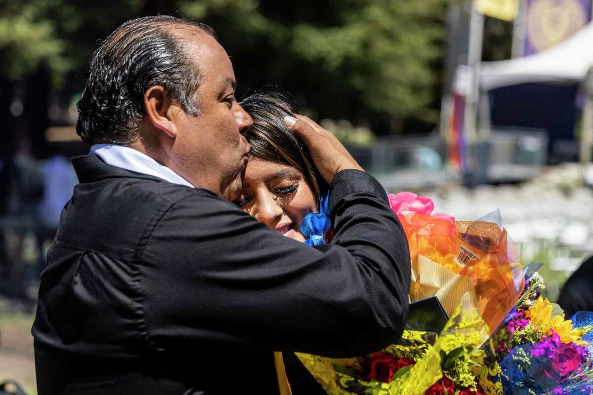 Ariana Arellano is embraced by her father, Alfredo, after she graduated with a biology degree at Mills College in Oakland.