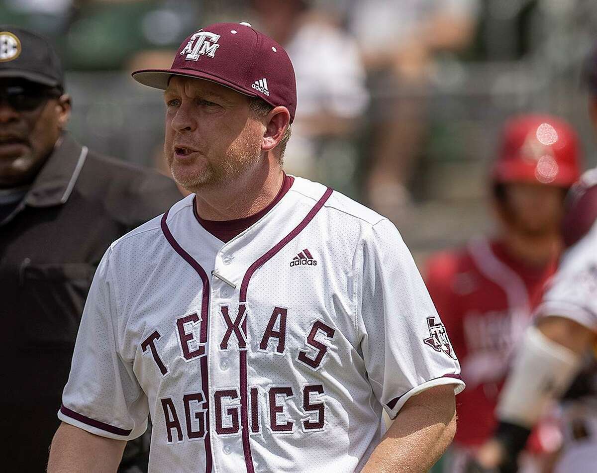 Texas A&M baseball coach Jim Schlossnagle speaks with the umpires during an SEC game against Arkansas in College Station on Saturday, April 23, 2022.