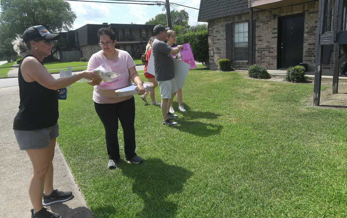 Block walkers stop at an apartment complex on McFaddin Street to distribute voter materials during a rally for women's and abortion rights at the Jefferson County Democratic headquarters Saturday. Photo made Saturday, May 14, 2022. Kim Brent/The Enterprise