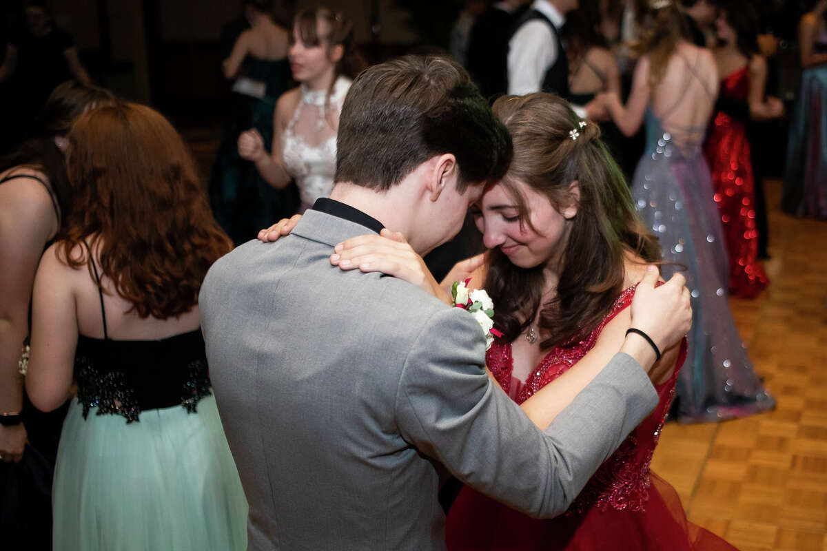 Hannah Cauchi and Josh Kennedy dance together as students from Midland and Dow High attend their joint prom Saturday, May 14, 2022 at the Great Hall Banquet & Convention Center in Midland.