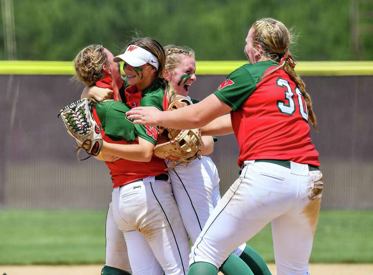 The Woodlands softball celebrates its Region II-6A quarterfinal victory over Grand Oaks on Saturday May 14, 2022 at Magnolia High School.