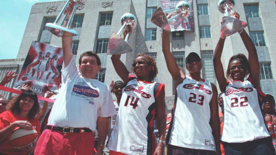 CONTACT FILED: HOUSTON COMETS Comets coach Van Chancellor, Cynthia Cooper, Tammy Jackson, and Sheryl Swoops hold up four trophies representing their four straight WNBA championships during a rally after a parade in downtown Houston, 8/29/00. (Buster Dean/Chronicle)
