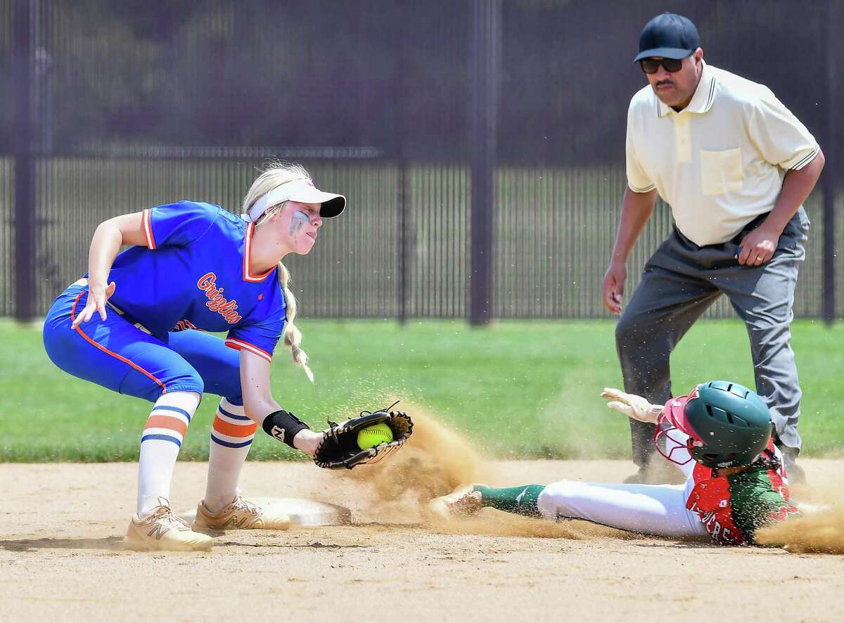 Woodlands Victoria Serrano (17) slides safely into second base beating the tag by Grand Oaks Kaet Dunbar (24) in the first inning during a Region II-6A quarterfinals softball game at Magnolia High School on Saturday, May 14, 2022. Woodlands beat Grand Oaks 14-11 in 7 innings.
