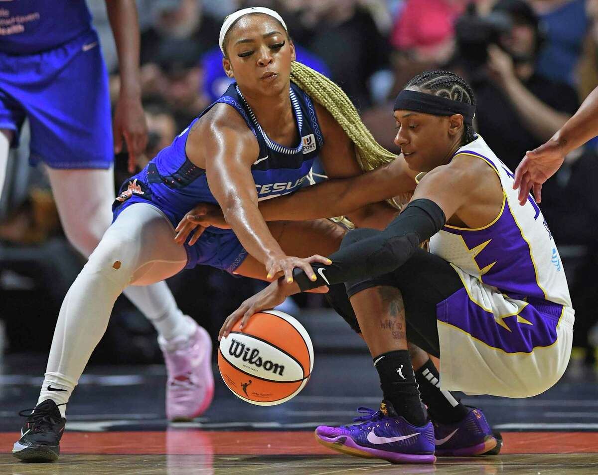 Connecticut Sun forward DiJonai Carrington, left, pressures Los Angeles Sparks guard Brittney Sykes, right, during a WNBA basketball game Saturday, May 14, 2022, in Uncasville, Conn. (Sean D. Elliot/The Day via AP)