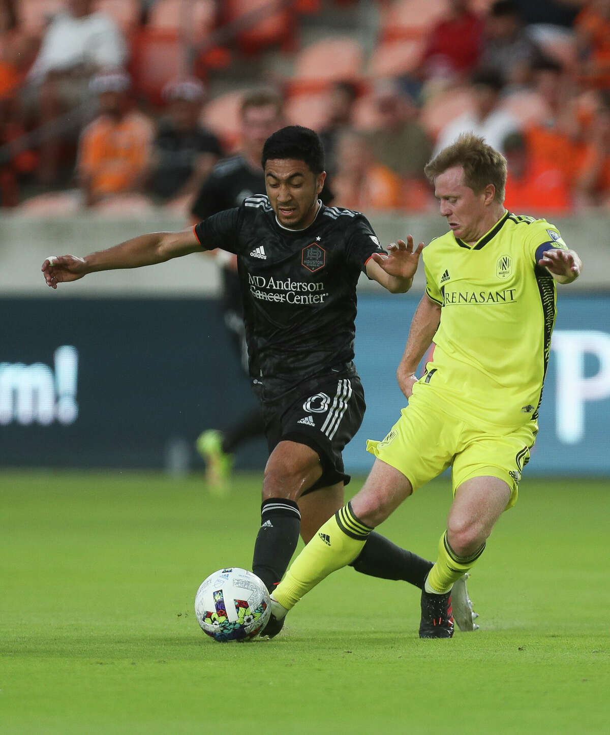 Houston Dynamo FC midfielder Memo Rodriguez (8) pokes the ball away from Nashville SC midfielder Dax McCarty (6) during the first half of an MLS match at PNC Stadium on Saturday, May 14, 2022, in Houston.