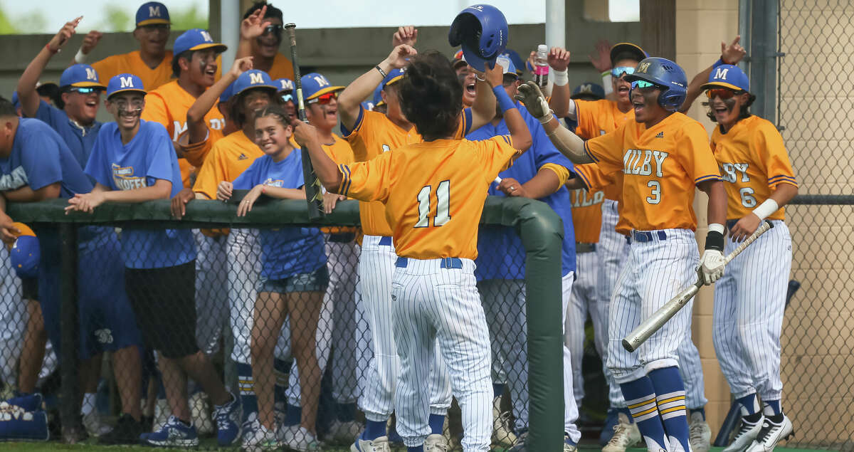 Milby Buffalos Arthur Perez (11) celebrates with teammates after scoring a run in the top of the first inning during the Region III-5A area playoffs- Game 2 high school baseball game between the Milby Buffaloes and Santa Fe Indians at Santa Fe High School in Santa Fe, Texas.