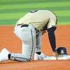 Alexander senior Marco Villanueva takes a knee at second base following the Bulldogs’ defeat in the Area Round on Friday night to the Edinburg Vela Sabercats.