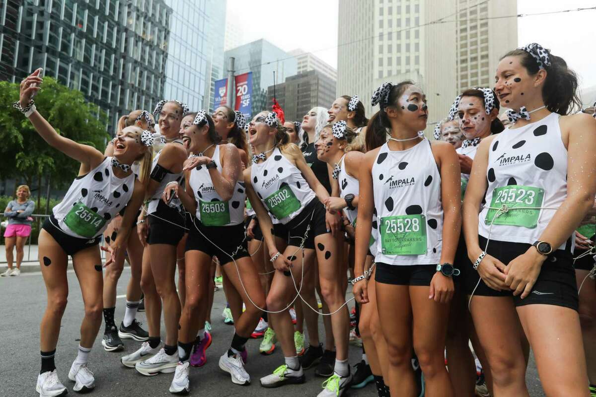 A pack of spot-on Dalmatians prepares to take to the streets for the 108th Bay to Breakers event.