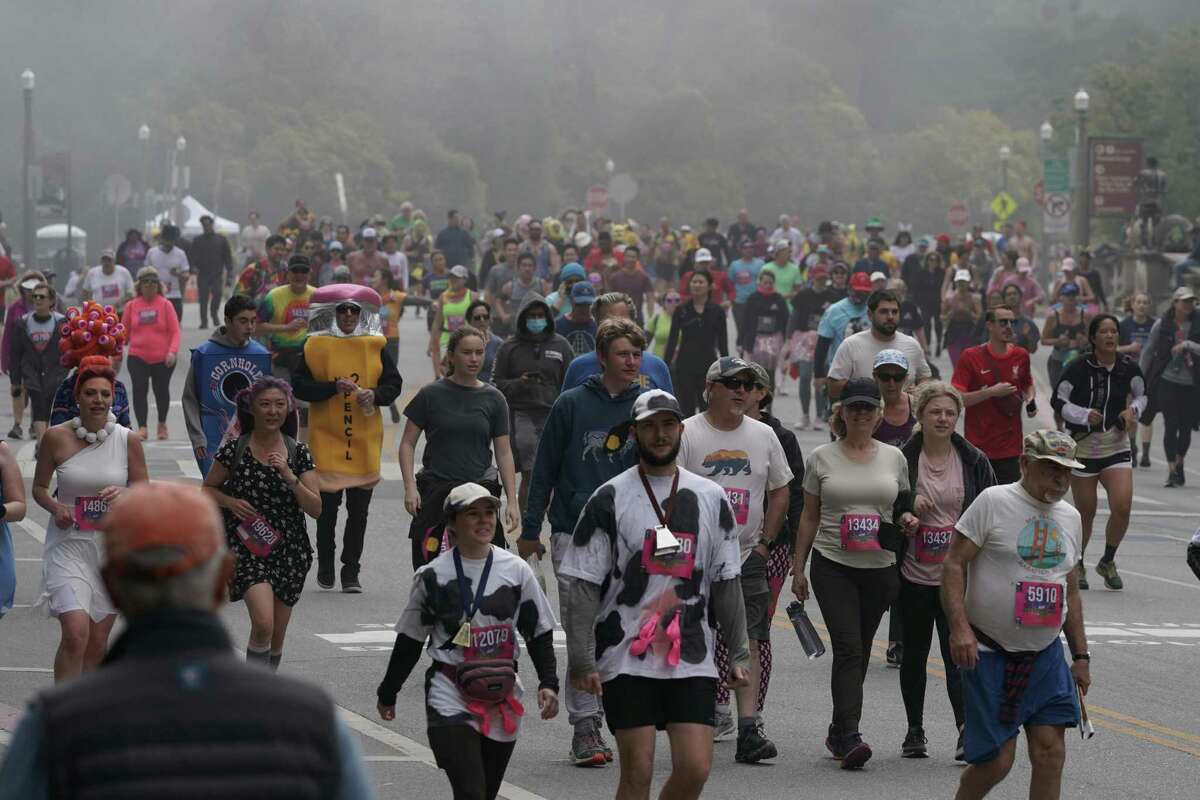 Participants pass through a foggy Golden Gate Park in the Bay to Breakers footrace Sunday.