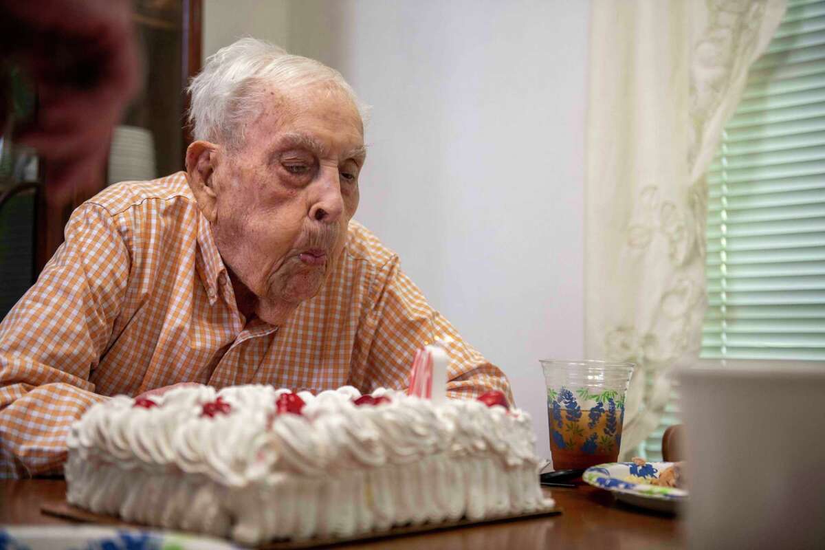 Pearl Harbor veteran Kenneth Platt blows out candles as he celebrates his 101st birthday with friends and family, at his home in San Antonio on Sunday.