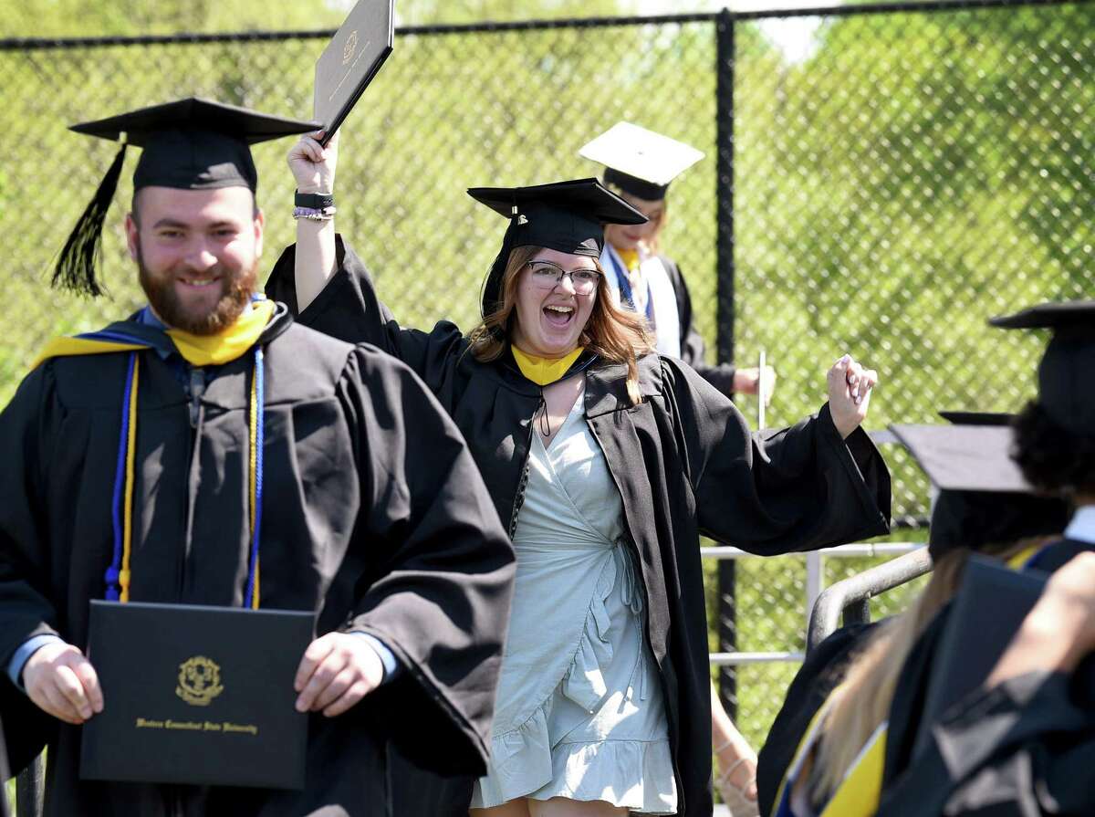 Dianna Benz, of Danbury, center, celebrates receiving her diploma on Sunday from Western Connecticut State University at commencement exercises at the Macricostas School of Arts & Sciences.
